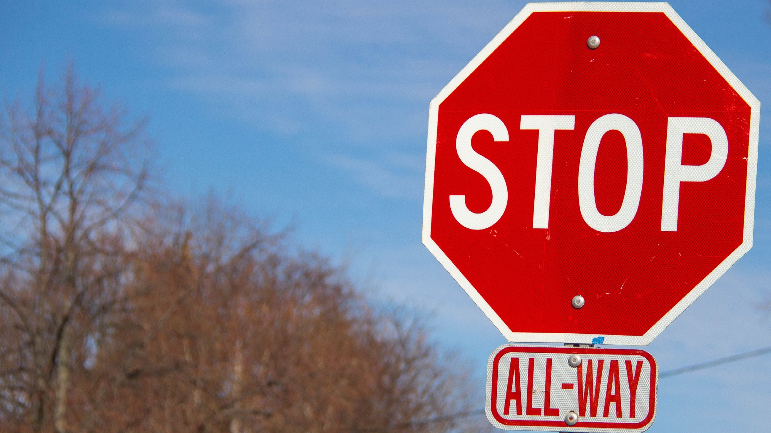 A photo of an all-way stop sign.