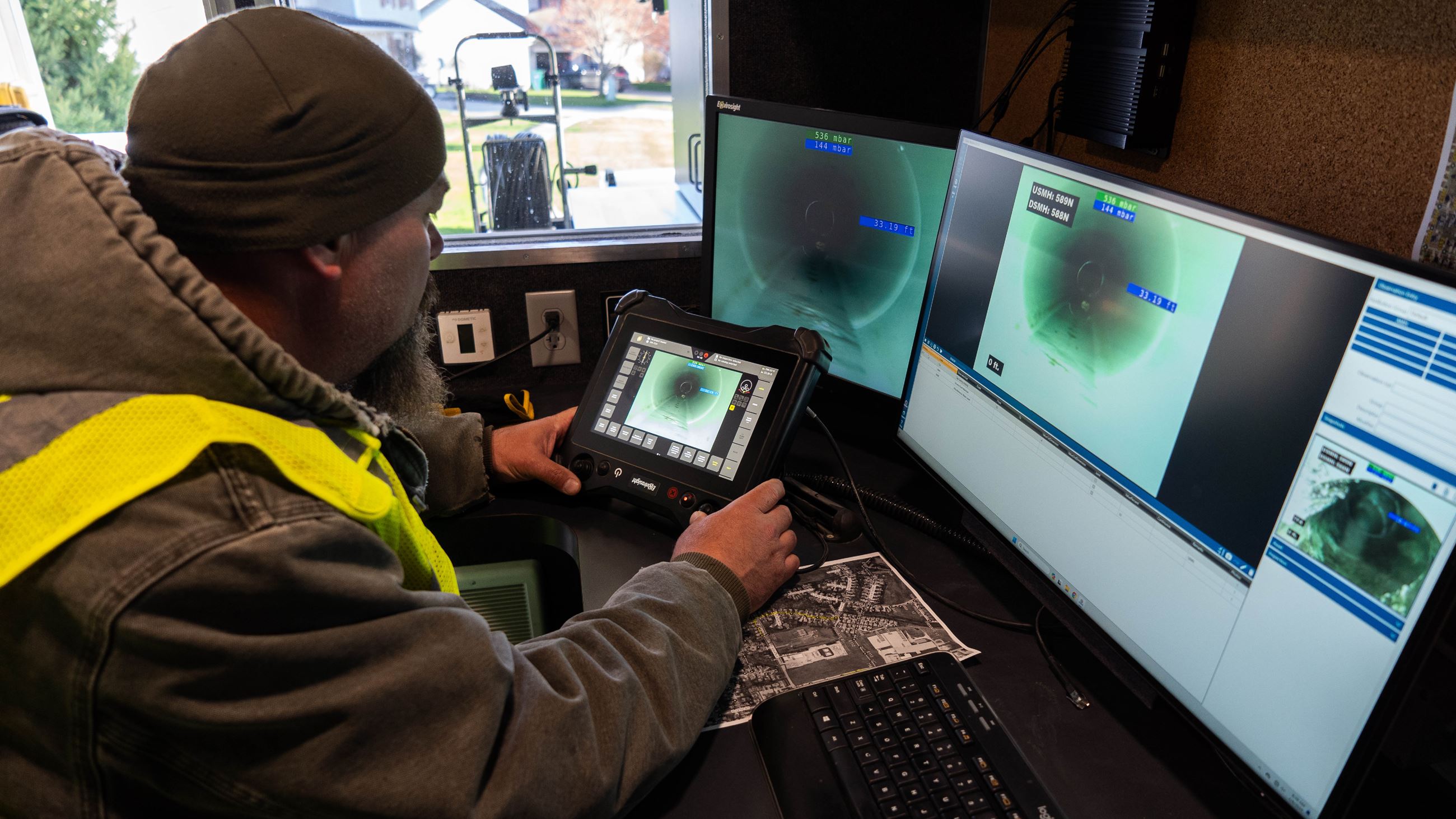 A City of Indianola employee with the Water Resource Recovery Department inspects a sewer line.