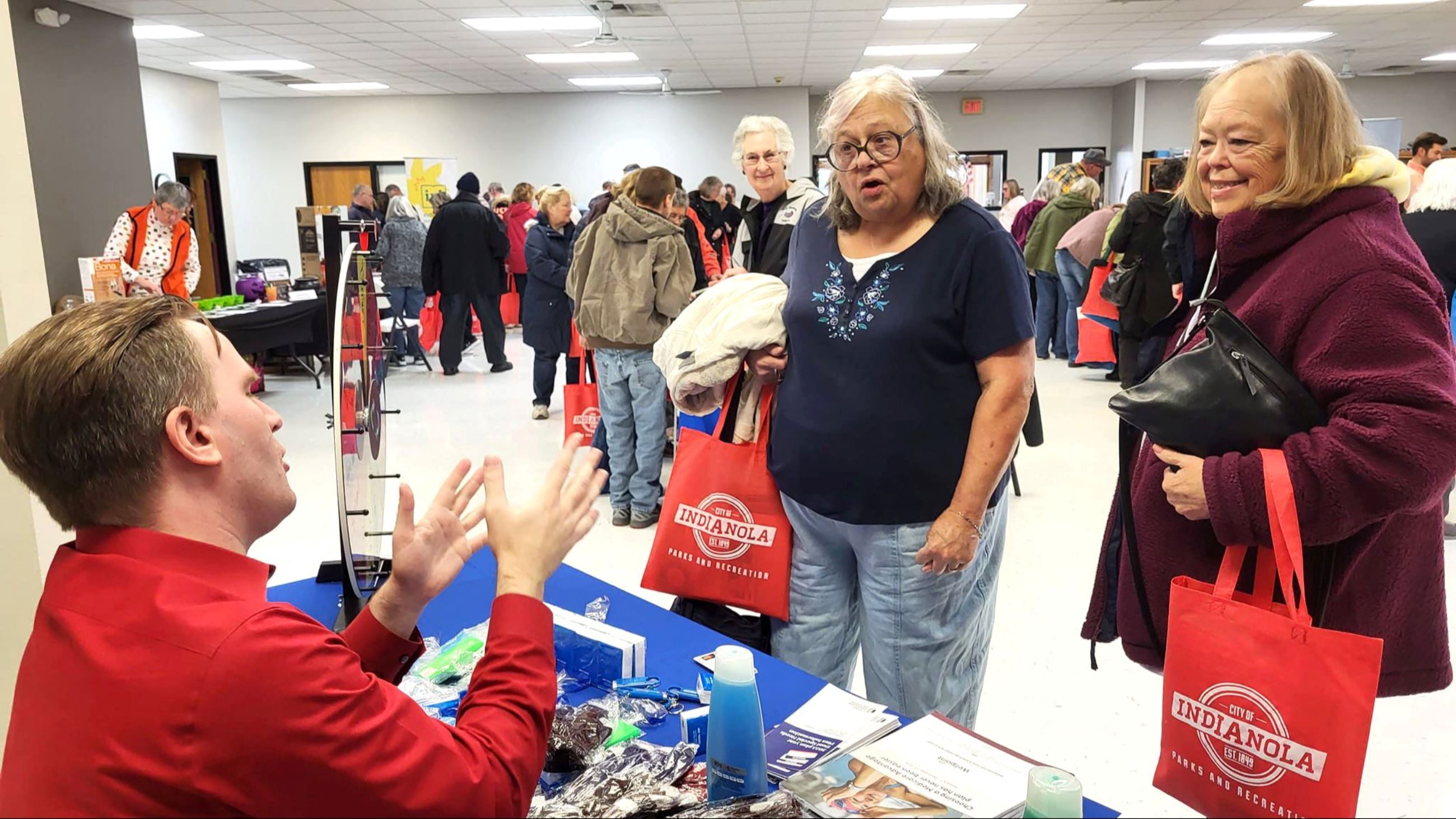 Women speak to a vendor at the 2023 Fall Festival and Open House at the Indianola Activity Center