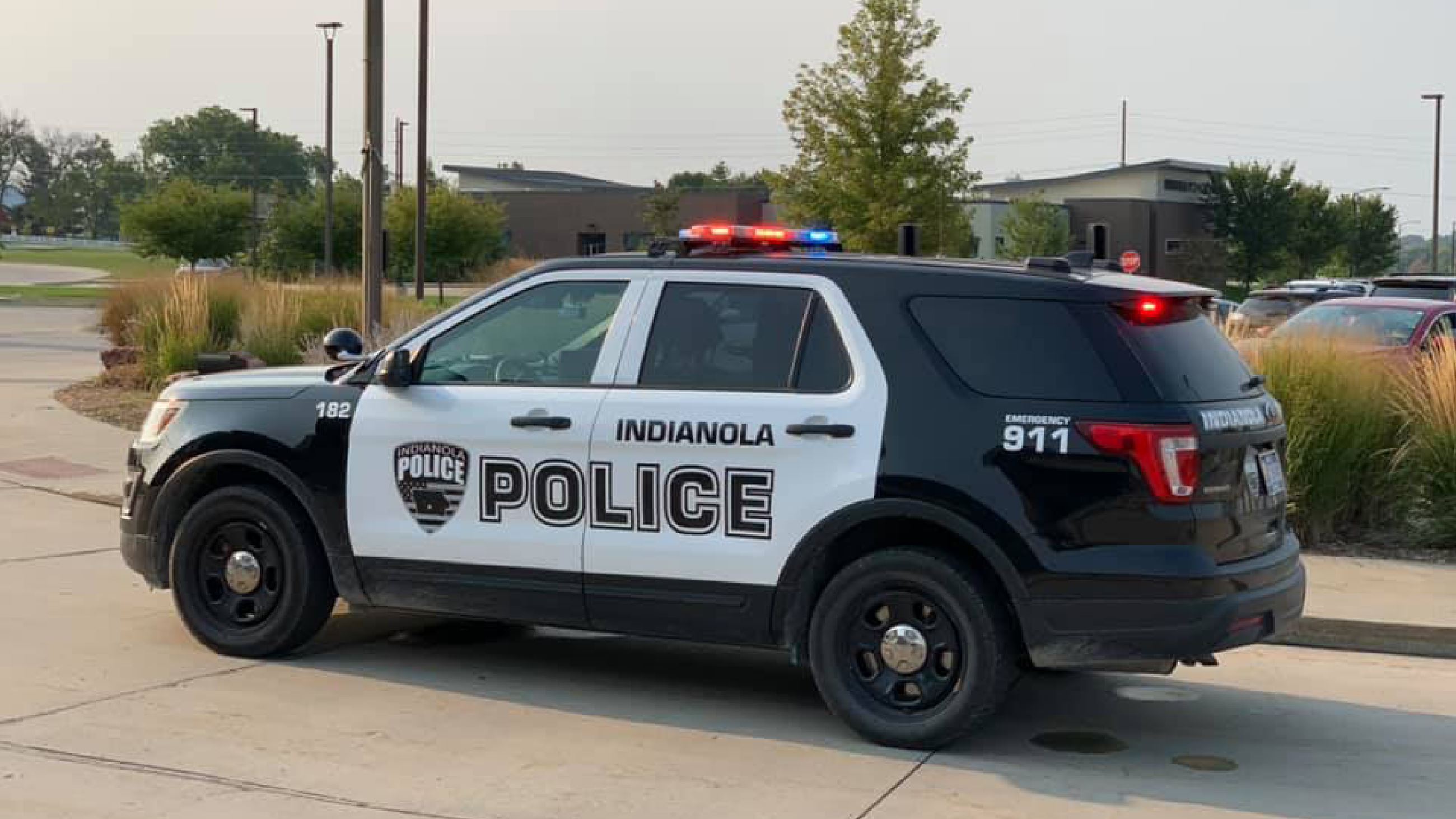 An Indianola Police Department vehicle is parked along a road.