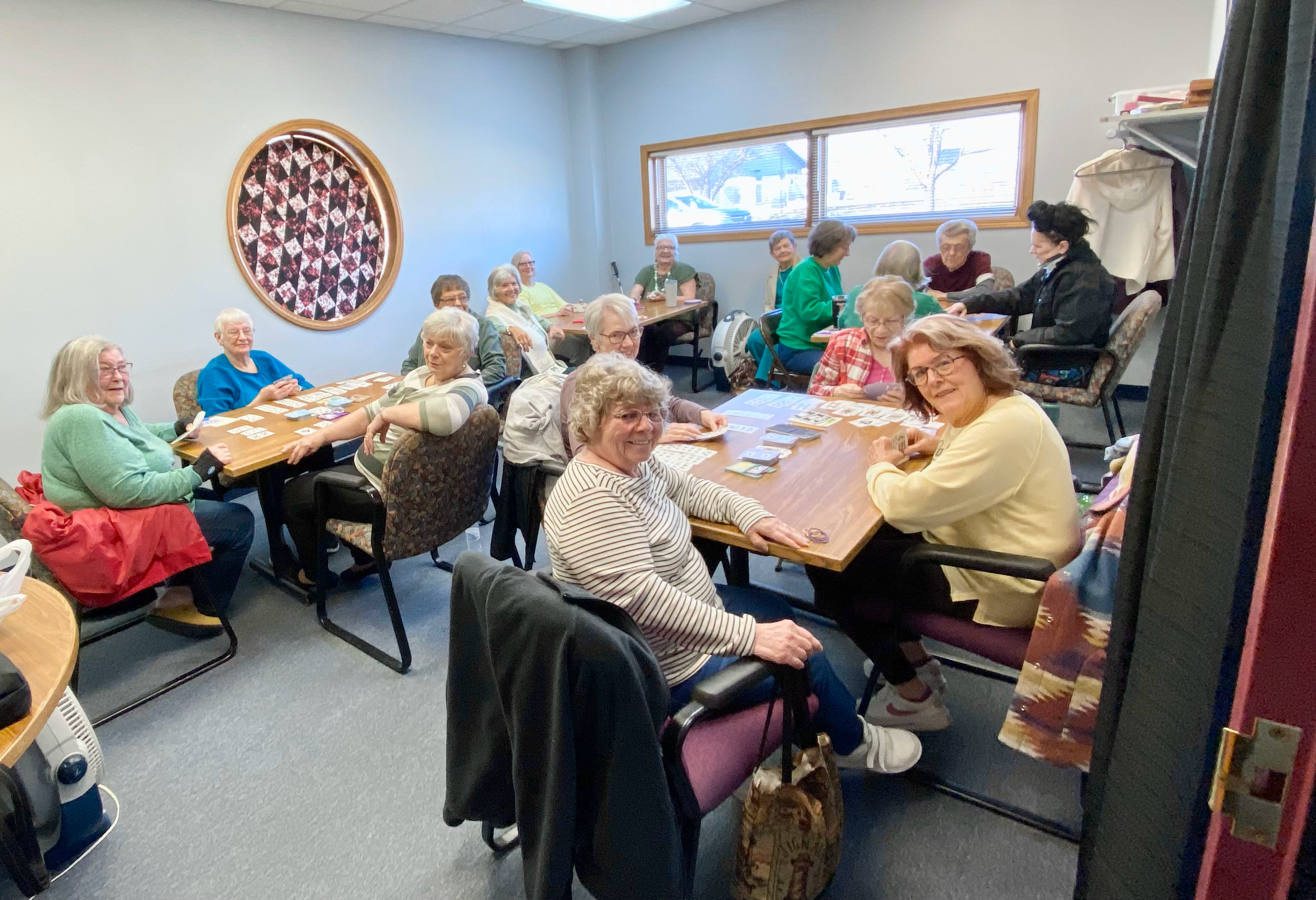 A room is filled with people playing cards