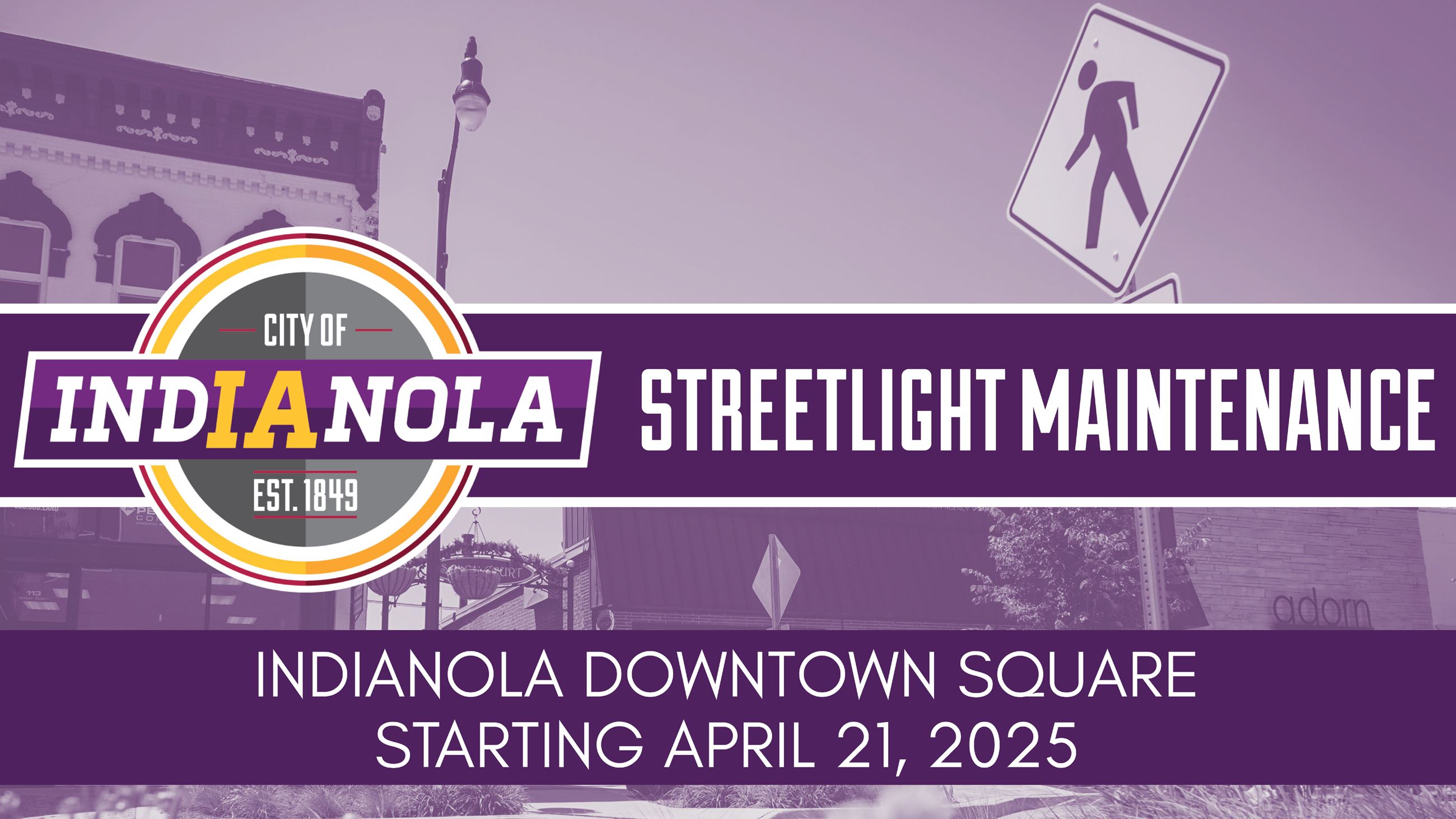 A streetlight and walking hazard sign near a row of buildings and street.