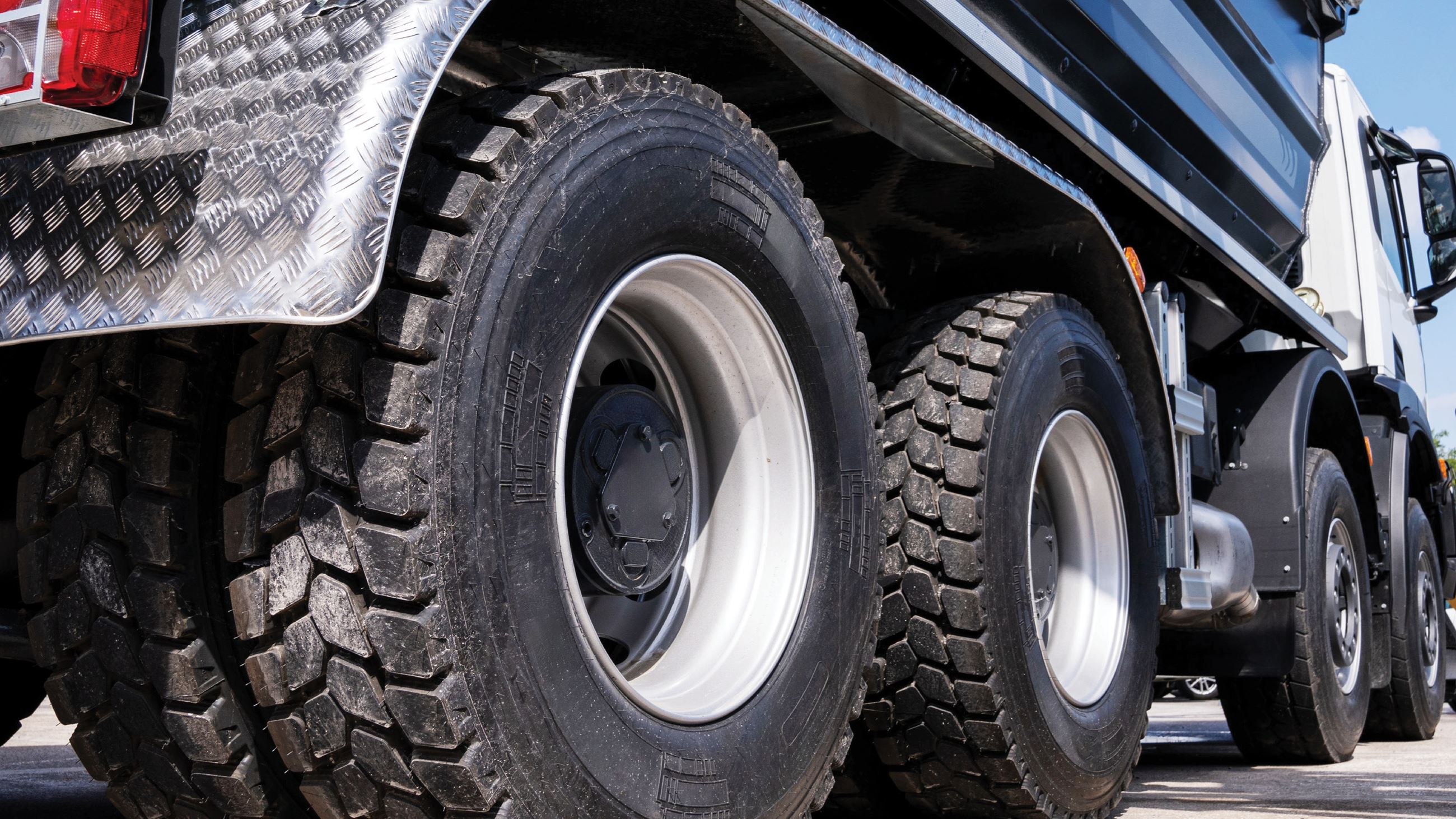 A large semi truck is parked in a street.