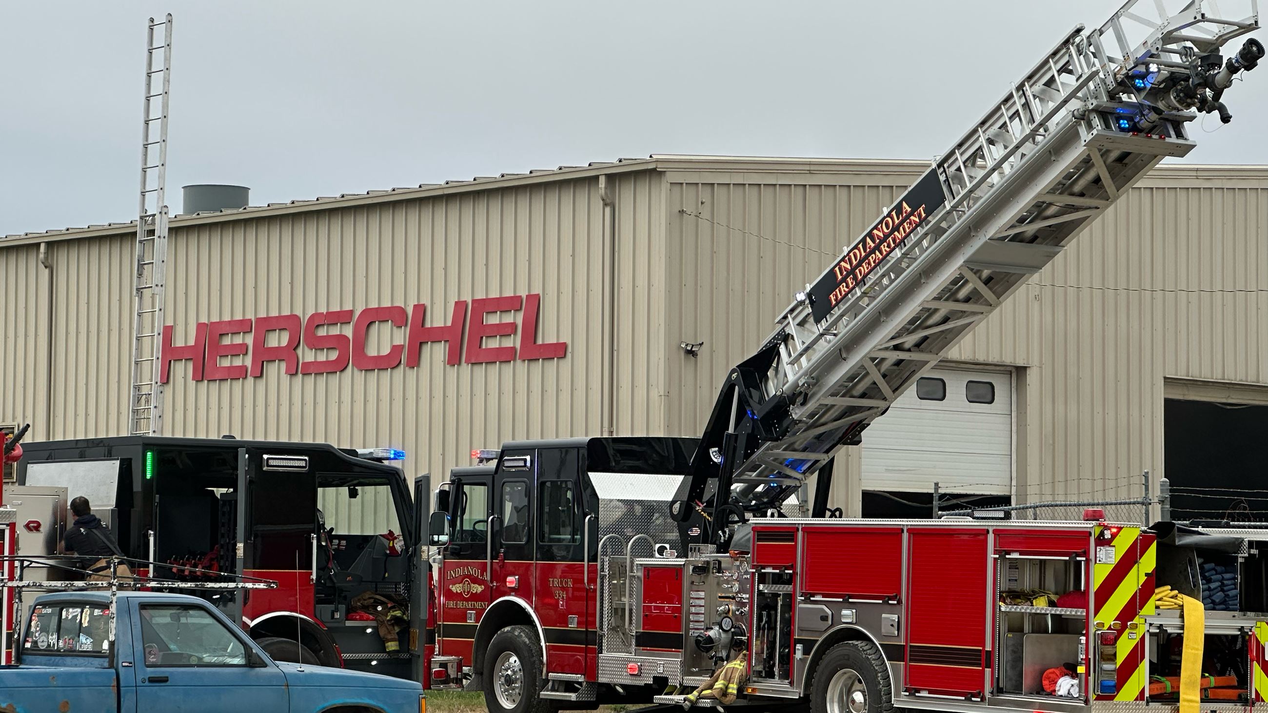 A fire truck and vehicles outside the Herschel Parts facility in Indianola, Iowa