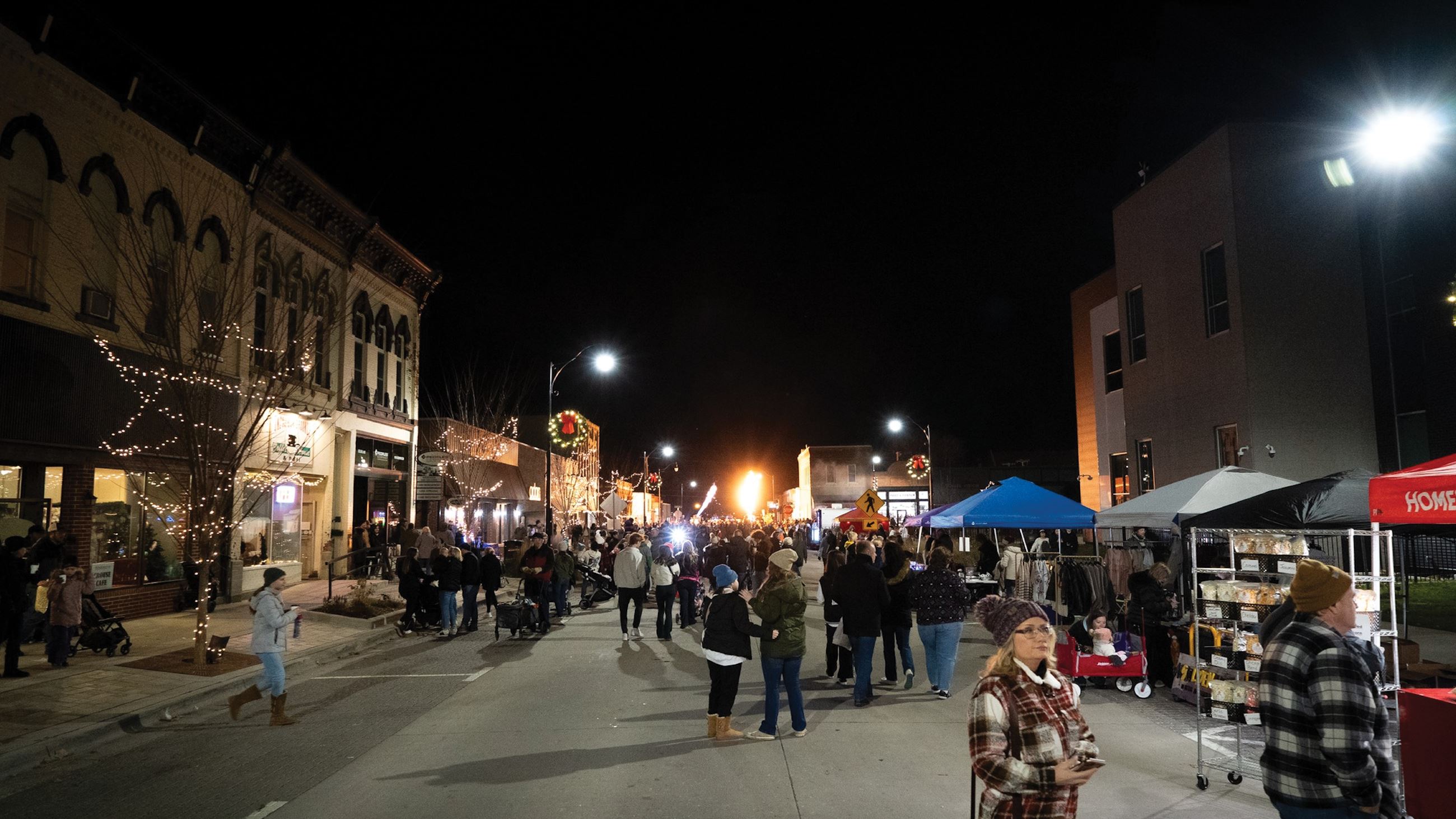 Large number of people in the street attending the 2024 Home for the Holidays event in Indianola.